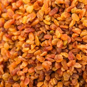 Top view of a heap of dried golden raisins, perfect for culinary and healthy eating visuals.