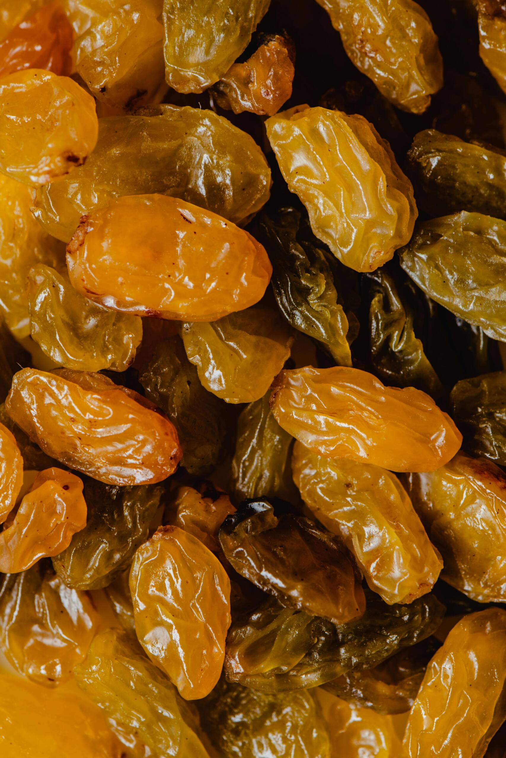 Close-up view of golden raisins showcasing their natural texture and vibrant colors.